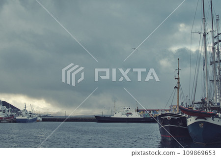 Ships in the harbor and on the quay of Tromso, Norway 109869653