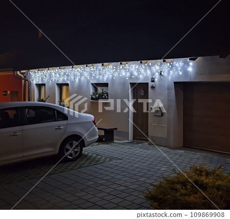 Festive Christmas lFestive Christmas lighting of the house. Holiday Christmas lights on the house in winter. House illumination during Christmas and New Year Festive Christmas lFestive Christmas lighting of the house. Holiday Christmas lights on the house in winter. House illumination during Christmas and New Year 109869908