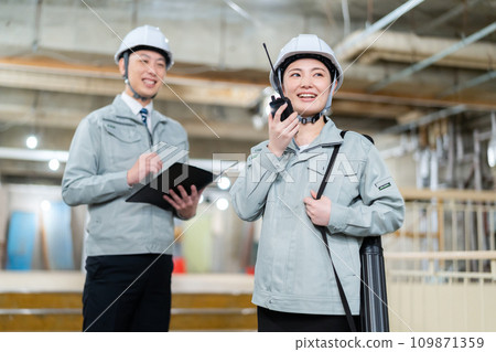 Male and female engineers having a meeting at a construction site 109871359