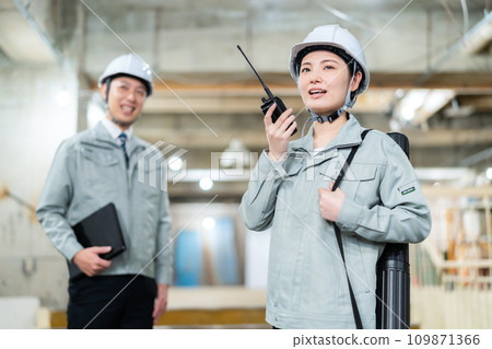 Male and female engineers having a meeting at a construction site Male and female engineers having a meeting at a construction site 109871366
