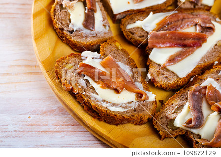 Toasts with salted anchovies and butter 109872129