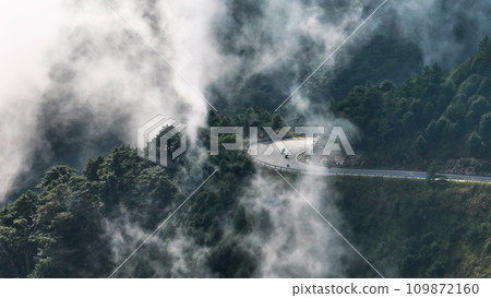 Aerial view of motorcycle rider and curvy road on the  mountains 109872160