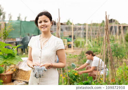 Asian woman at vegetable garden Asian woman at vegetable garden 109872938