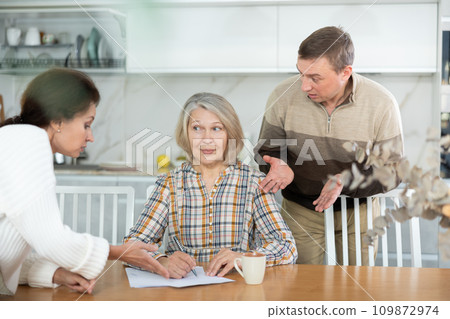 Old woman signing papers 109872974