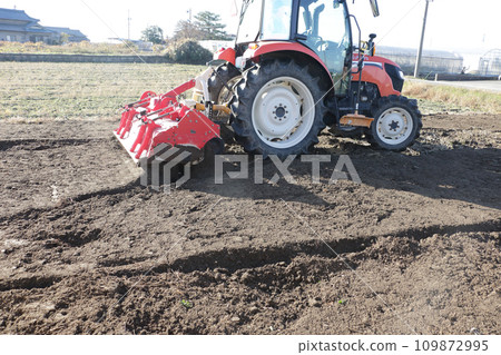tractor working in the field tractor working in the field 109872995
