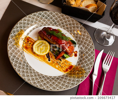 Salmon in soy-honey sauce with fried vegetables 109873417