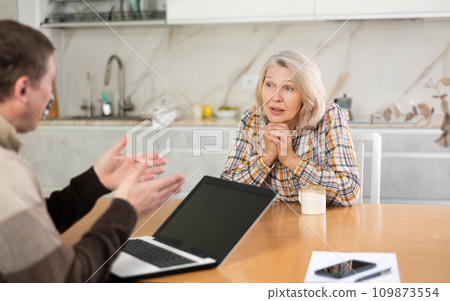 Old woman considering offer from agent Old woman considering offer from agent 109873554