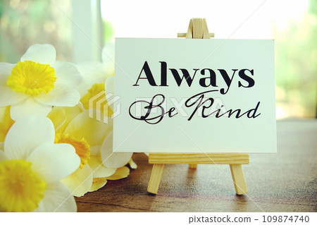 Always be kind text message on paper card with wooden easel on wooden table background, inspiration motivation concept Always be kind text message on paper card with wooden easel on wooden table background, inspiration motivation concept 109874740