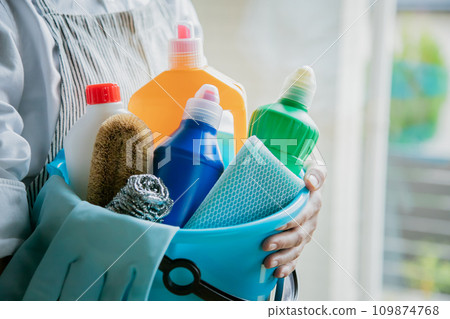 Woman holding cleaning tools in a bucket - cleaning image material Woman holding cleaning tools in a bucket - cleaning image material 109874768