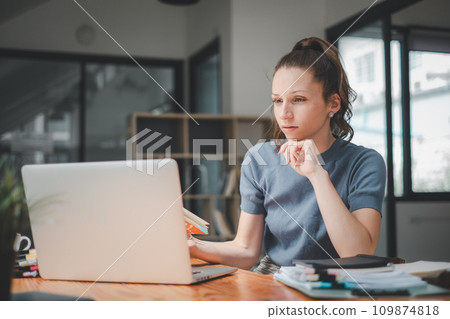 Overworked businesswoman suffering from headache and thinking how to end work. Overworked businesswoman suffering from headache and thinking how to end work. 109874818