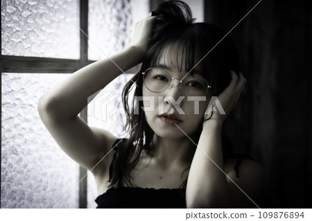 Young woman with glasses in an ennui atmosphere Young woman with glasses in an ennui atmosphere 109876894