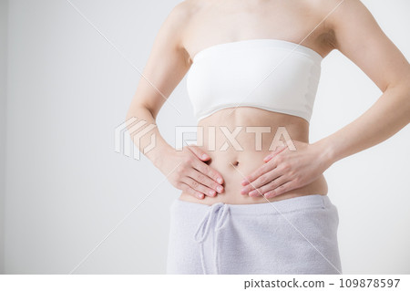 Young woman with hands on waist and stomach, no face Young woman with hands on waist and stomach, no face 109878597