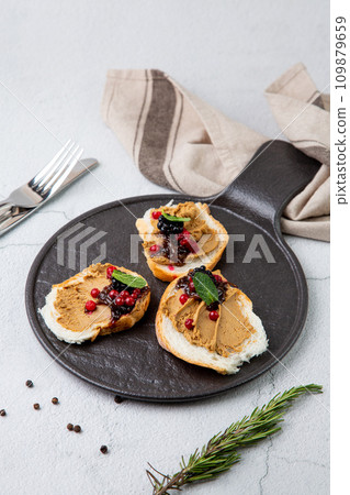 canapes with pate, mint leaves and berries, top view canapes with pate, mint leaves and berries, top view 109879659