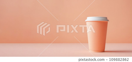 coffee cup on table. Monochrome peach fuzz background. side view, banner. Modern trendy tone. paper cup in trendy color of year 2024 Peach Fuzz 109882862