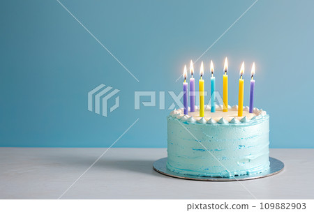 Celebration birthday cake and seven colorful birthday candles. blue background. Happy birthday concept. copy space 109882903
