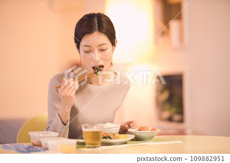 Night routine of a business woman who eats dinner with prepared dishes 109882951