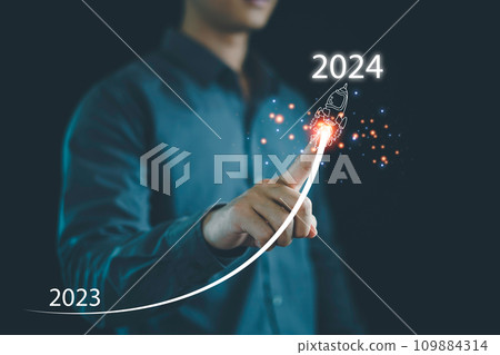 Businessman hand draws line for increasing arrow from 2023 to 2024, New goals, Plans and visions for next year 2024, Preparation merry Christmas and happy new year concept. new business. 109884314