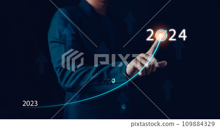Businessman hand draws line for increasing arrow from 2023 to 2024, New goals, Plans and visions for next year 2024, Preparation merry Christmas and happy new year concept. new business. 109884329
