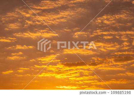 Beautiful nature morning with orange, yellow sunshine and fluffy clouds. Beautiful colorful dramatic sky with clouds at sunset or sunrise. 109885198