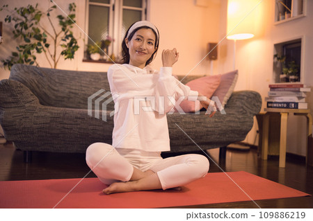 Woman relaxing and stretching night routine 109886219