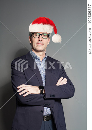 Christmas man Santa standing on gray background, portrait 109886227