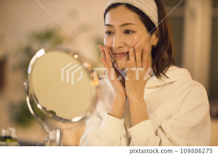 Night routine of a woman taking care of her skin after taking a bath 109886275