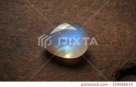 Natural precious moonstone on a brown background. Natural stone adularia 109886614