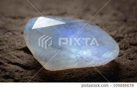 Natural precious moonstone on a brown background. Natural stone adularia Natural precious moonstone on a brown background. Natural stone adularia 109886639