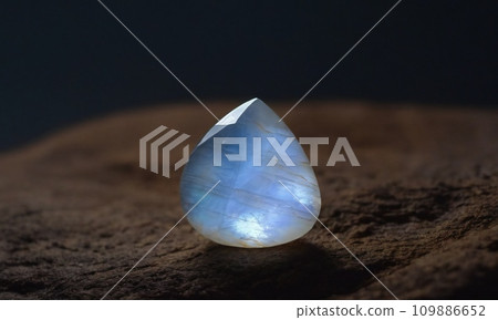 Natural precious moonstone on a brown background. Natural stone adularia 109886652