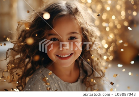 little girl smiling and laughing while a silver balloon explodes 109887048