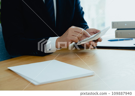 穿著西裝的男人的手用計算機計算 穿著西裝的男人的手用計算機計算 109887940