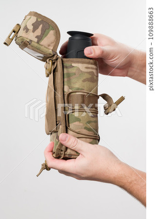 Military monocular in a case for storage and portability. 109888663