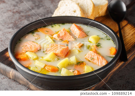 Creamy fish soup with salmon, potatoes, onions, carrots, dill and celery close-up on a plate. Horizontal Creamy fish soup with salmon, potatoes, onions, carrots, dill and celery close-up on a plate. Horizontal 109889214