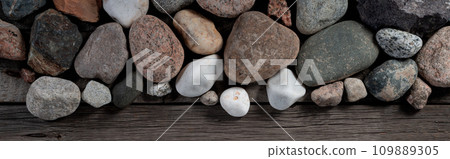 Stones on Wooden Rustic Background. Nature, Spa and Relaxation Thematic Mockup Wallpaper for Clipart. Stones on Wooden Rustic Background. Nature, Spa and Relaxation Thematic Mockup Wallpaper for Clipart. 109889305