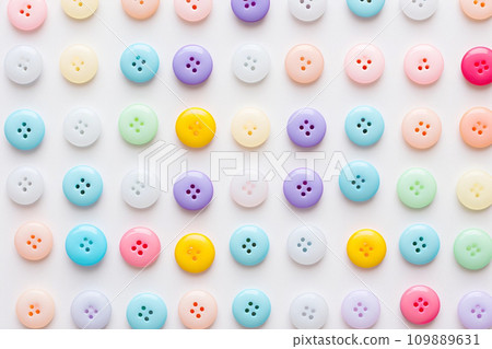 Cute plastic beads and buttons abstract background in pastel colors Cute plastic beads and buttons abstract background in pastel colors 109889631