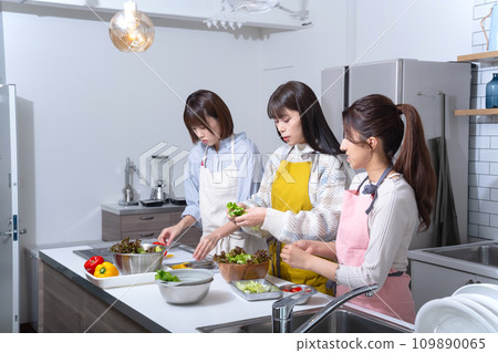 Three women making salad in the kitchen Three women making salad in the kitchen 109890065