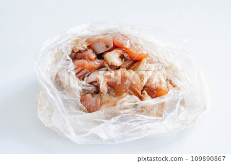 Chicken thighs seasoned in a plastic bag Chicken thighs seasoned in a plastic bag 109890867