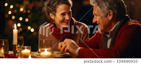 older woman and older man enjoying christmas meal at table older woman and older man enjoying christmas meal at table 109890910