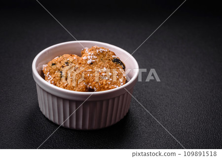 Delicious sweet round sponge cookies sprinkled with coconut flakes Delicious sweet round sponge cookies sprinkled with coconut flakes 109891518