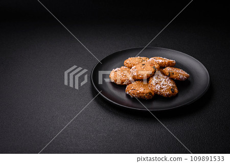 Delicious sweet round sponge cookies sprinkled with coconut flakes Delicious sweet round sponge cookies sprinkled with coconut flakes 109891533