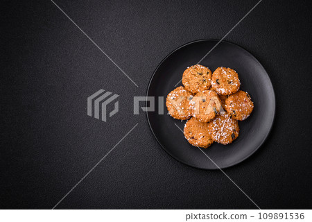 Delicious sweet round sponge cookies sprinkled with coconut flakes Delicious sweet round sponge cookies sprinkled with coconut flakes 109891536