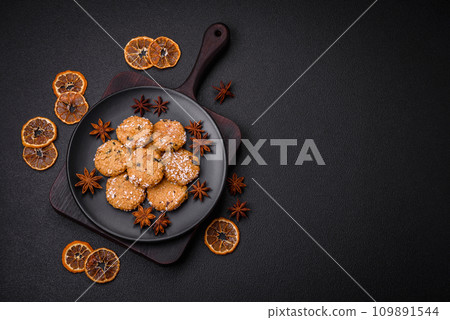 Delicious sweet round sponge cookies sprinkled with coconut flakes Delicious sweet round sponge cookies sprinkled with coconut flakes 109891544