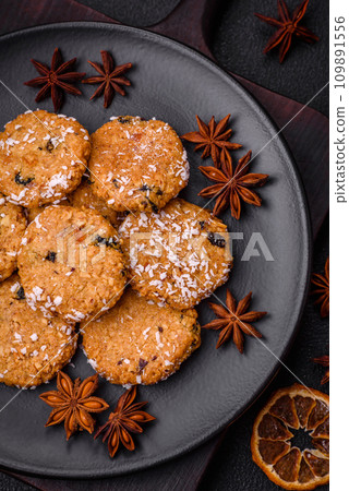 Delicious sweet round sponge cookies sprinkled with coconut flakes Delicious sweet round sponge cookies sprinkled with coconut flakes 109891556