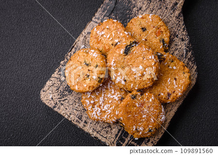 Delicious sweet round sponge cookies sprinkled with coconut flakes Delicious sweet round sponge cookies sprinkled with coconut flakes 109891560