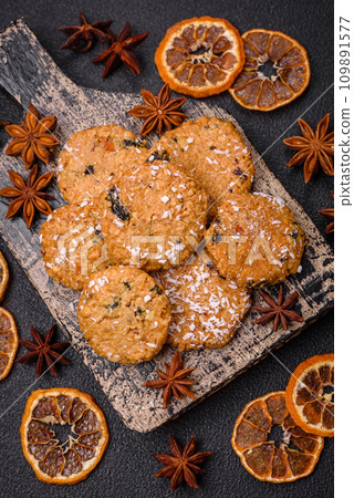 Delicious sweet round sponge cookies sprinkled with coconut flakes Delicious sweet round sponge cookies sprinkled with coconut flakes 109891577
