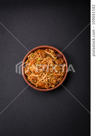 Delicious asian udon dish with vegetables, mushrooms, salt and spices Delicious asian udon dish with vegetables, mushrooms, salt and spices 109891582