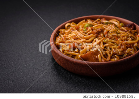 Delicious asian udon dish with vegetables, mushrooms, salt and spices Delicious asian udon dish with vegetables, mushrooms, salt and spices 109891583