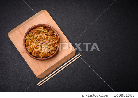 Delicious asian udon dish with vegetables, mushrooms, salt and spices 109891593