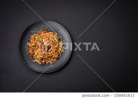 Delicious asian udon dish with vegetables, mushrooms, salt and spices Delicious asian udon dish with vegetables, mushrooms, salt and spices 109891615