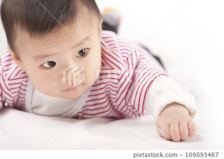 asian baby boy lying on bed asian baby boy lying on bed 109893467